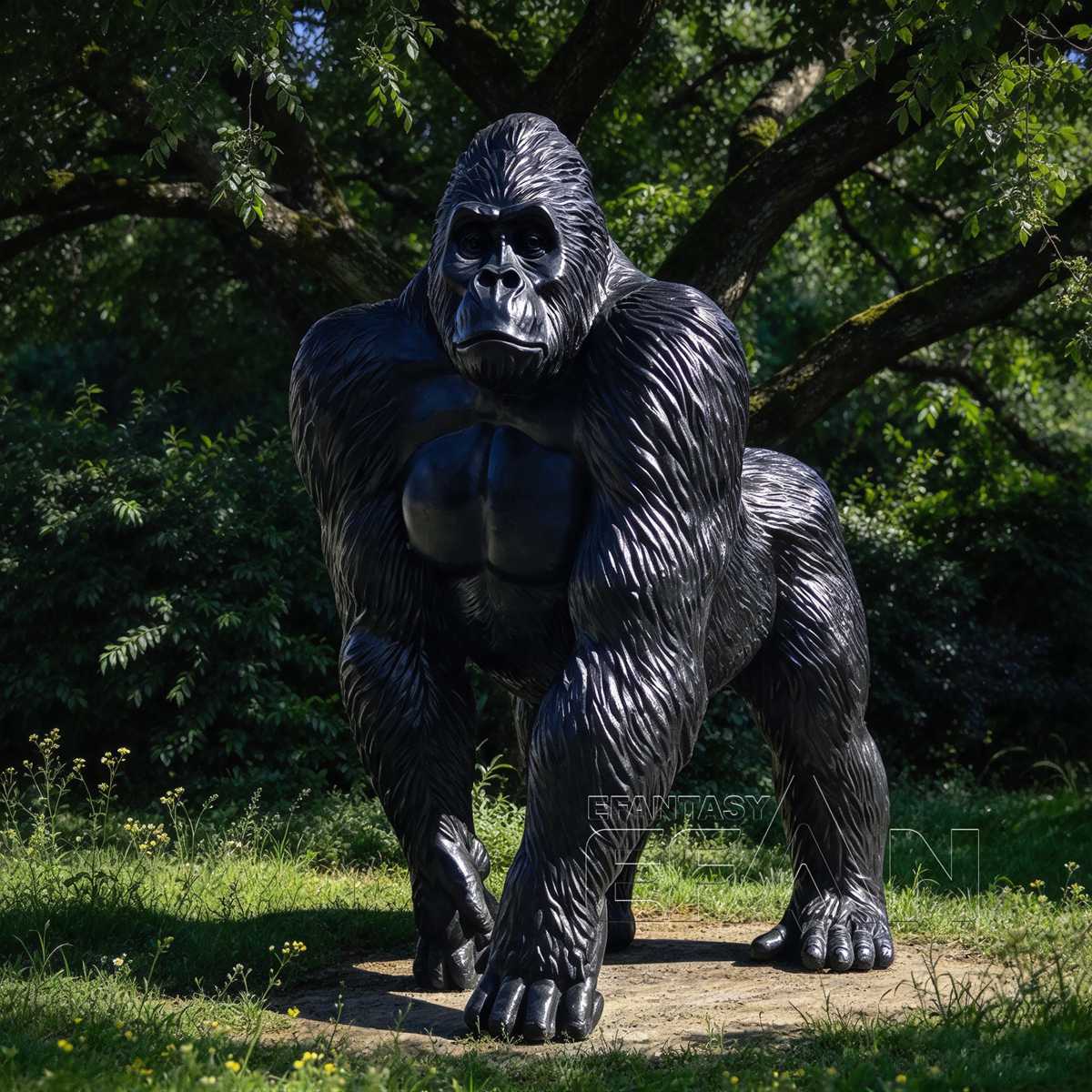 Front view of black bronze gorilla sculpture in a wooded garden