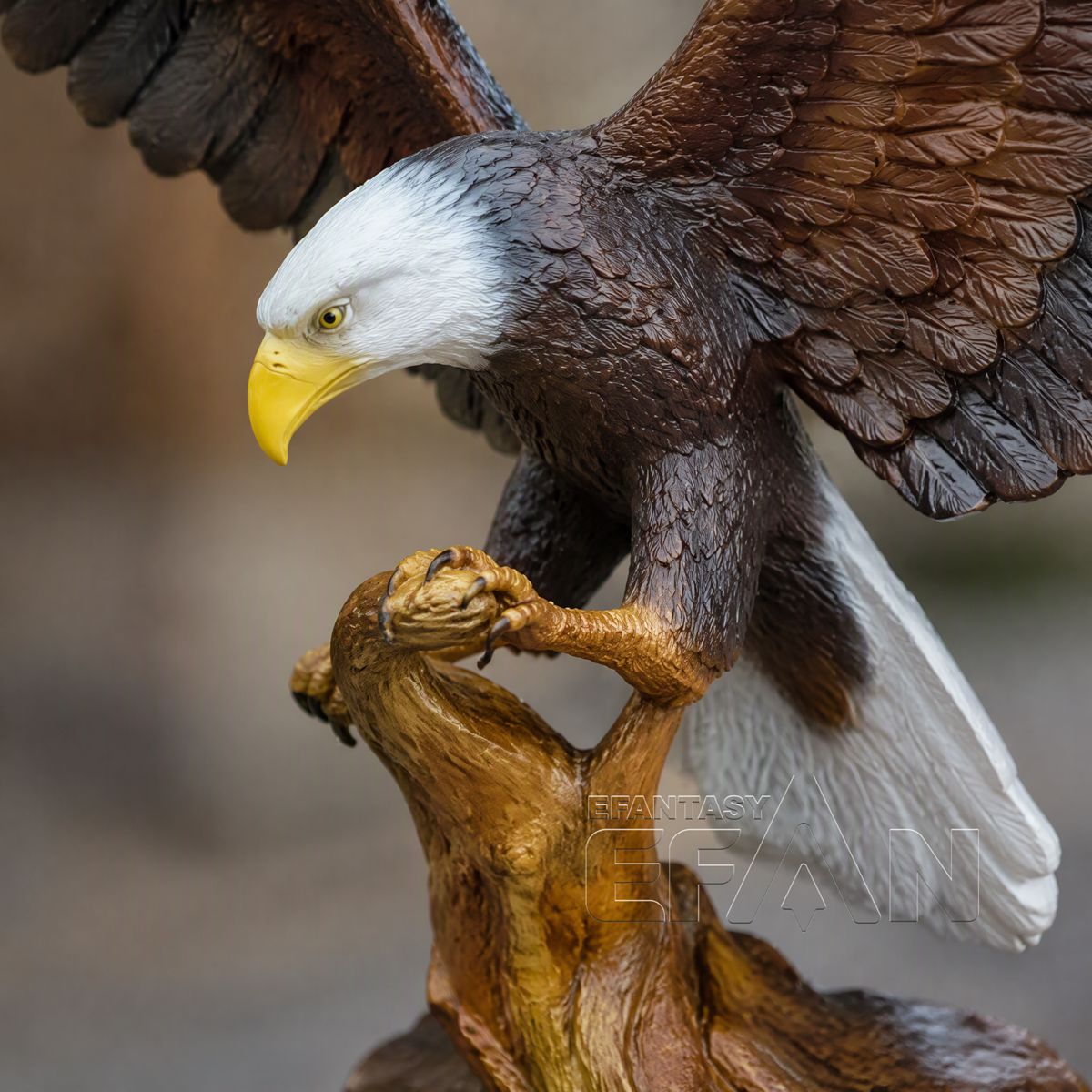 Close-up of bronze bald eagle sculpture showing yellow beak, feathers, and talons