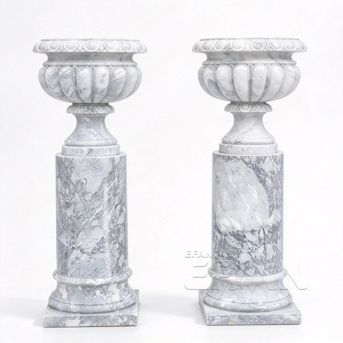Two white and gray marble urn planters with fluted bowls and cylindrical pedestals on a white background