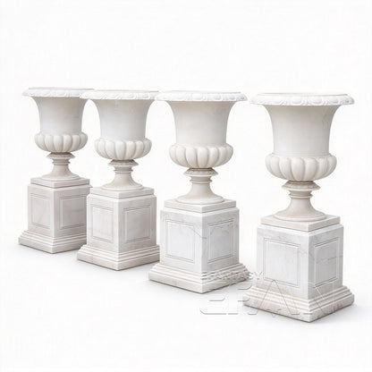 Four white marble flower pots with square pedestals on a white background
