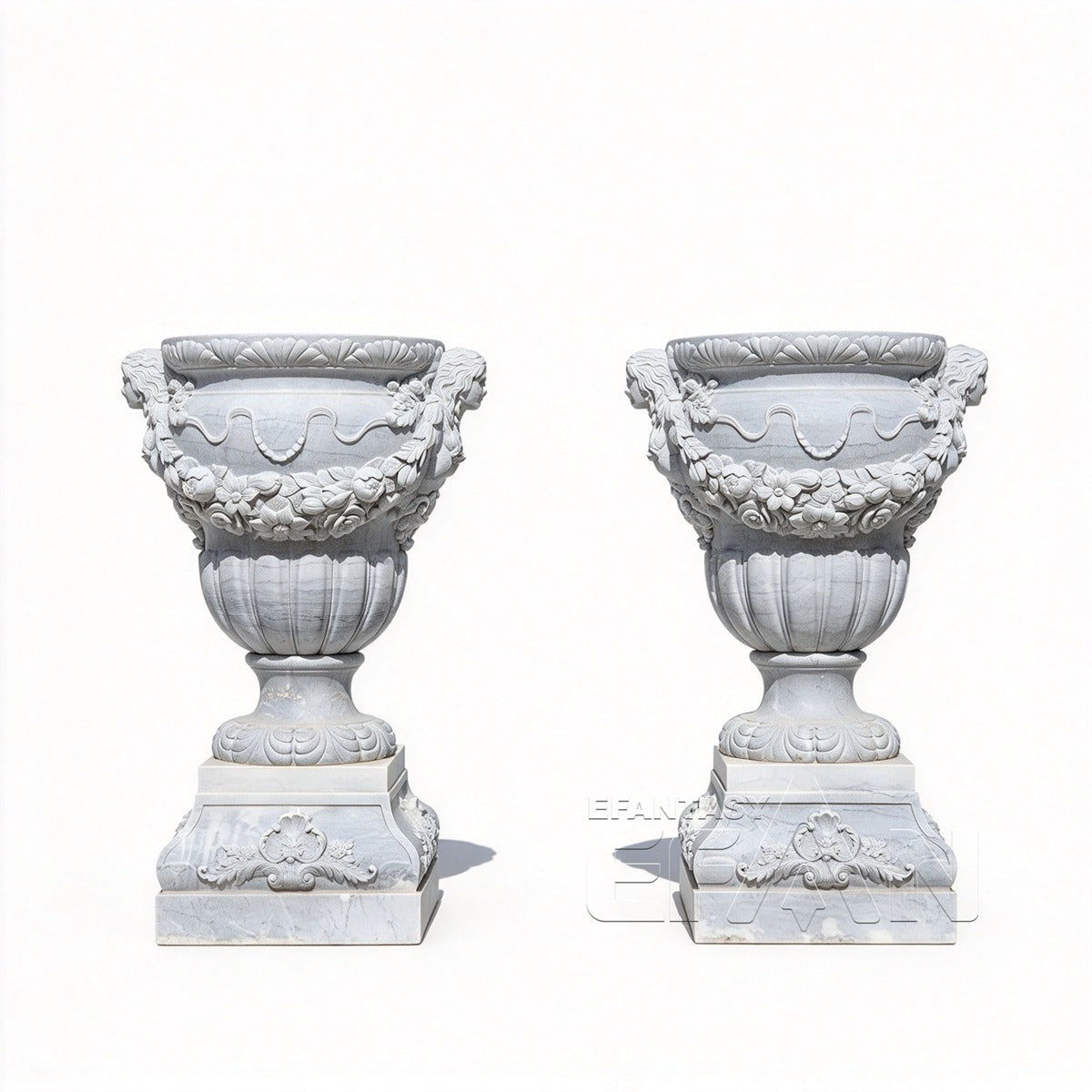 Two white marble relief urn planters with floral garlands and carved bases on a white background