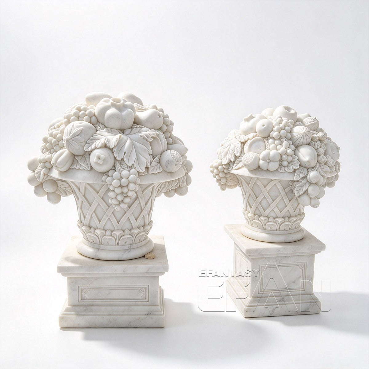 Two white marble fruit basket ornaments with carved grapes and lattice baskets on pedestals