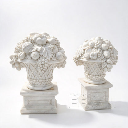 Two white marble fruit basket ornaments with carved grapes and lattice baskets on pedestals