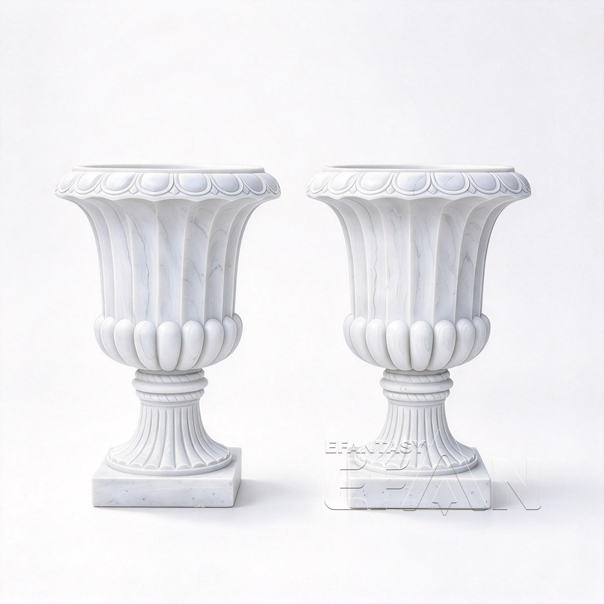 Pair of Roman Revival white marble urn planters on a white background, showing fluted bodies and square bases